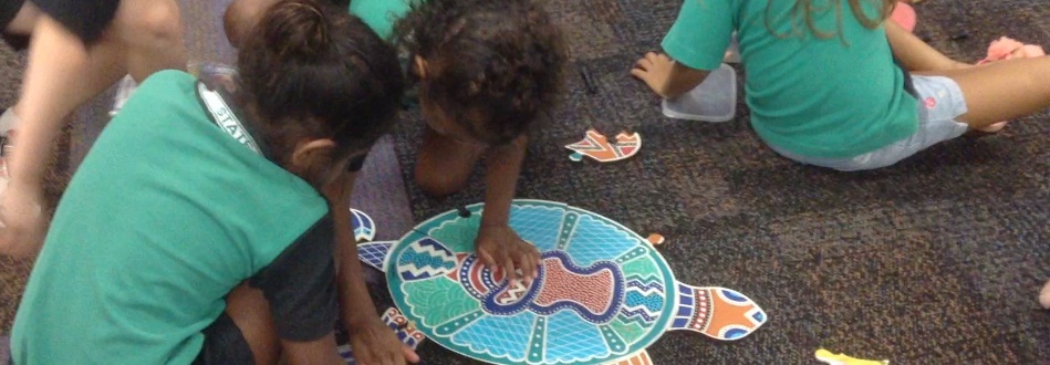 Students working on a puzzle in the library